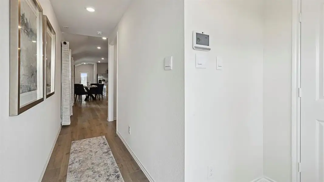 Hallway with dark wood-style floors and recessed lighting Hallway with dark wood-style floors and recessed lighting