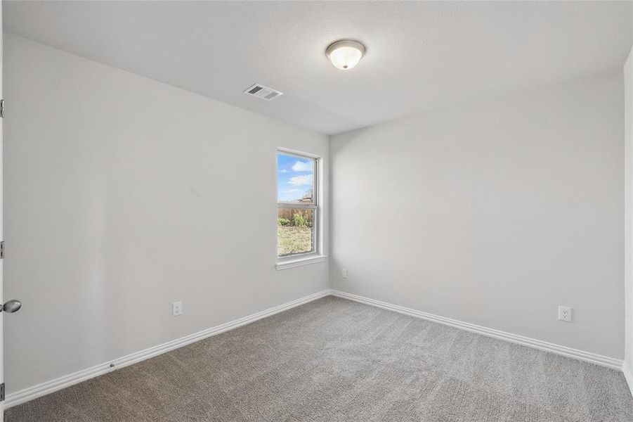 Unfurnished room with carpet flooring and baseboards Unfurnished room with carpet flooring and baseboards
