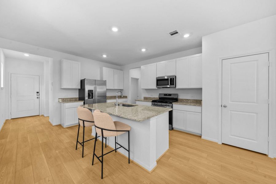 Granite countertops and a 5 burner stove compete this lovely kitchen.