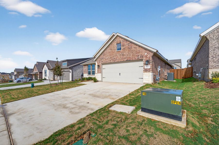 Front exterior of a new home in Liberty Pointe, Gainesville, TX, highlighting curb appeal (Image 21). Front exterior of a new home in Liberty Pointe, Gainesville, TX, highlighting curb appeal (Image 21).