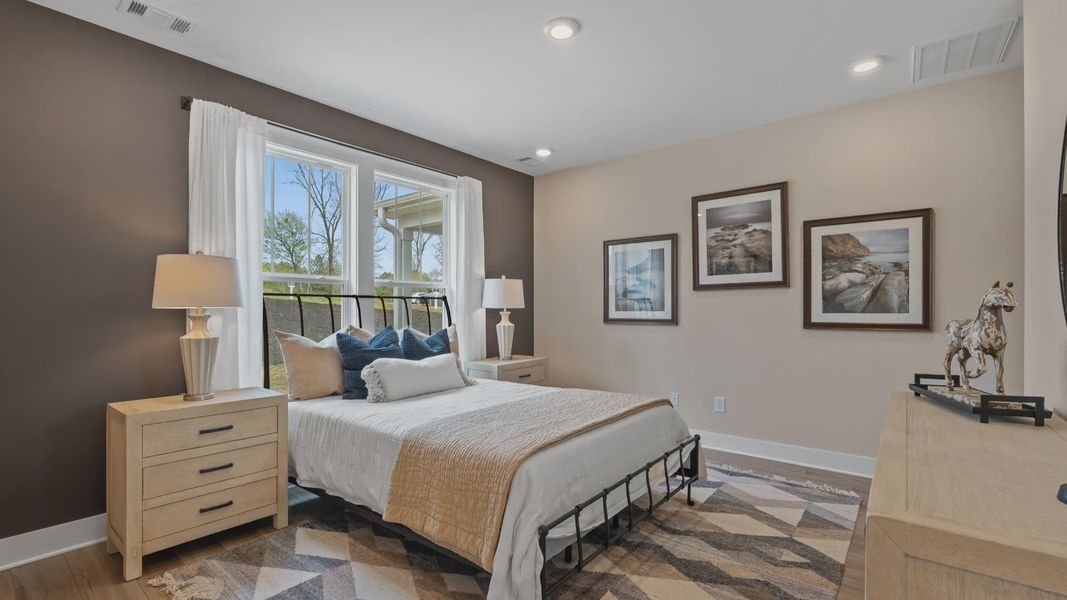 First-class hardwood floors and tasteful finishes elevate the private retreat of this exceptional primary suite