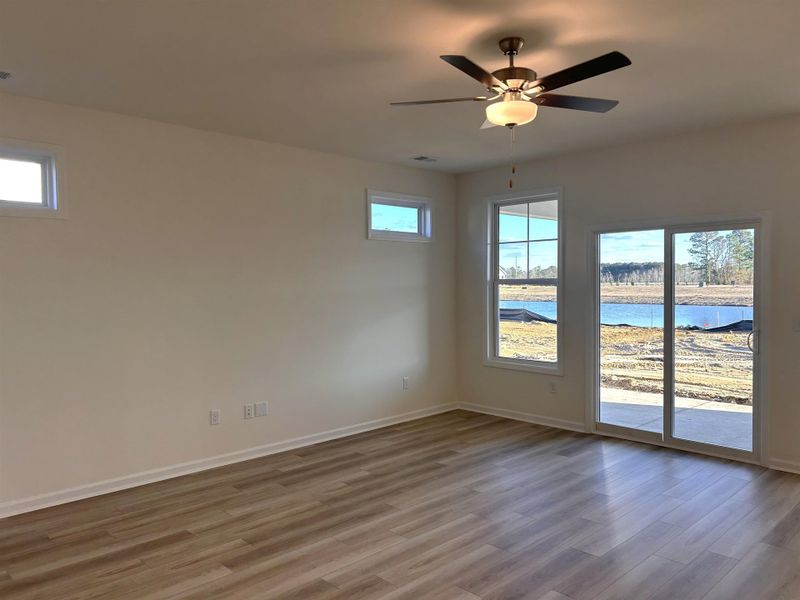 Empty room featuring light wood finished floors and a ceiling fan