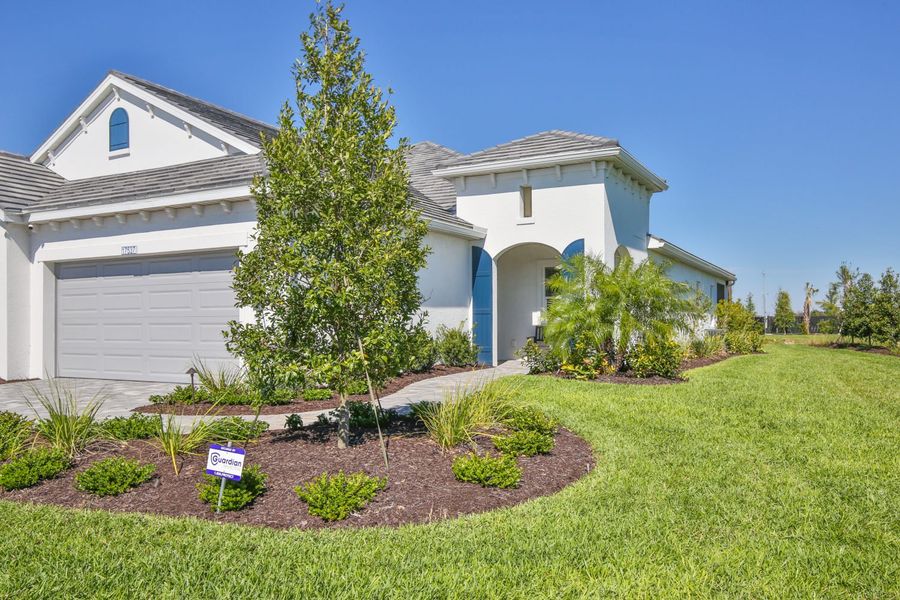 Representative exterior photo of a completed home built from the Tidewinds 2 by Neal Communities in Palm Grove, Bradenton, FL (Image 2). Representative exterior photo of a completed home built from the Tidewinds 2 by Neal Communities in Palm Grove, Bradenton, FL (Image 2).