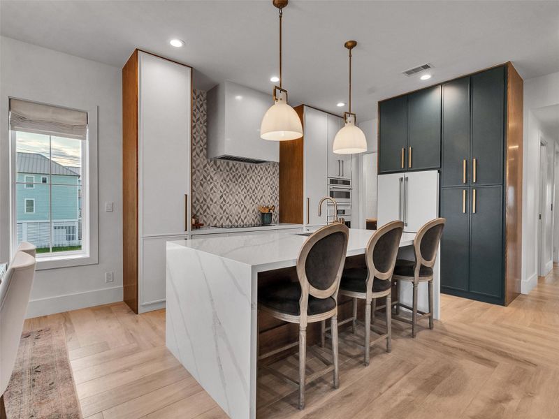 This inviting kitchen angle highlights the perfect blend of function and beauty — ideal for morning coffee at the breakfast bar or cooking up seaside favorites with friends. This inviting kitchen angle highlights the perfect blend of function and beauty — ideal for morning coffee at the breakfast bar or cooking up seaside favorites with friends.