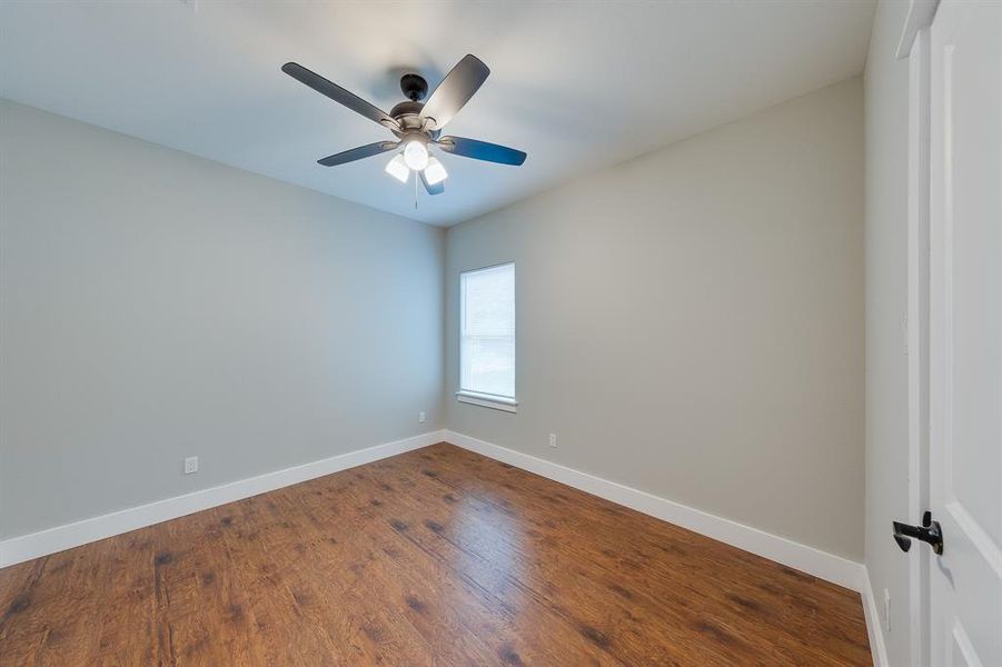 Third bedroom filled with natural light, creating a bright and airy space perfect for rest or a home office.