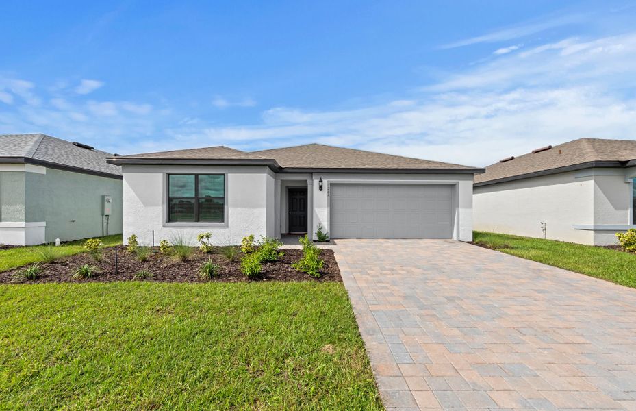 Front exterior of a new home in Caloosa Cove, Labelle, FL, highlighting curb appeal (Image 16).