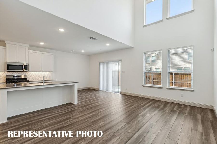 Our beautiful Baycliff plan features a wall of windows that flood the open concept main floor with natural light.  REPRESENTATIVE PHOTO