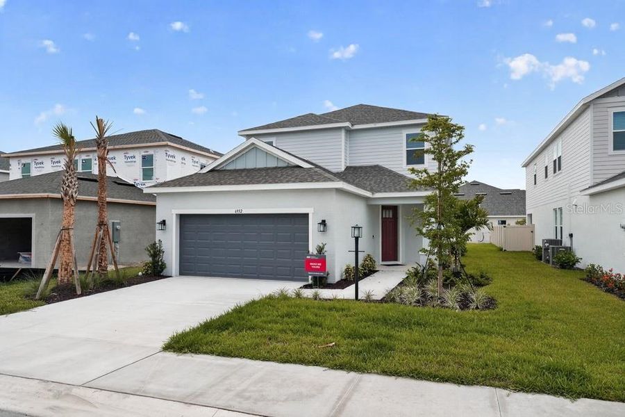 Front exterior of a new home in Tiburon, Nokomis, FL, highlighting curb appeal (Image 1). Front exterior of a new home in Tiburon, Nokomis, FL, highlighting curb appeal (Image 1).