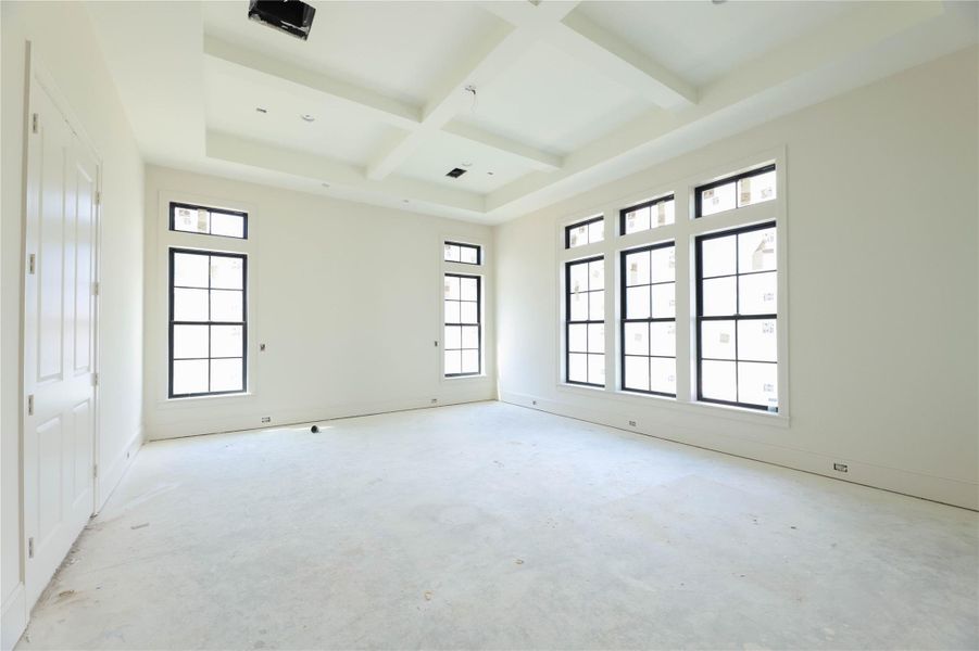 Primary Bedroom features engineered wood floors, coffered ceilings, Andersen windows, Metal frame door leading to the back patio & a masterful Primary Bathroom with over-sized shower, soak tub, 2 vanities & massive walk-in closet.