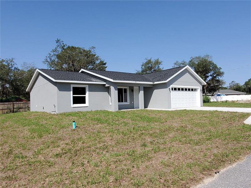 Front exterior of a new home in , Ocklawaha, FL, highlighting curb appeal (Image 19).