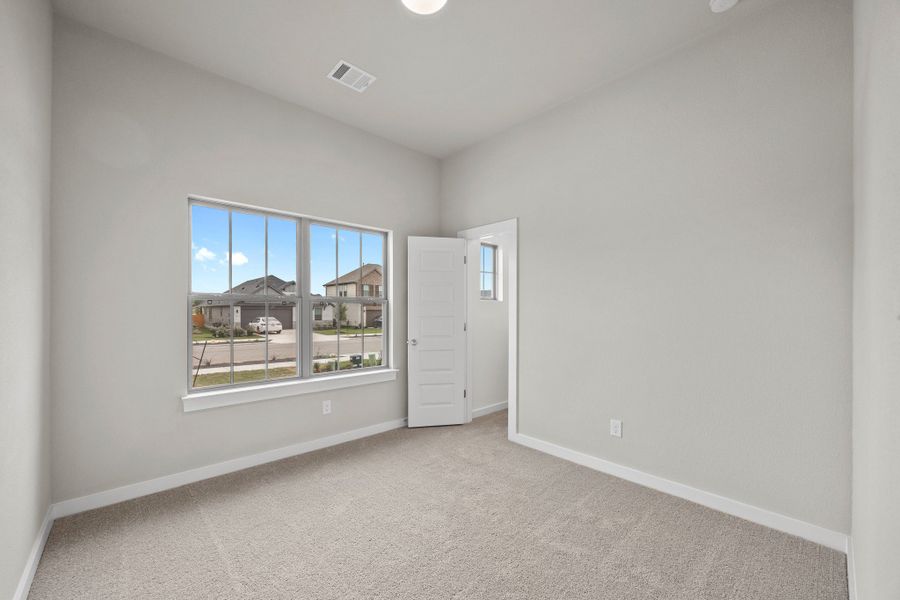 Bedroom in the Brazos home plan by Trophy Signature Homes – REPRESENTATIVE PHOTO