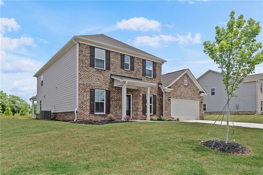 Front exterior of a new home in Anderson Point Estates, McDonough, GA, highlighting curb appeal (Image 2).