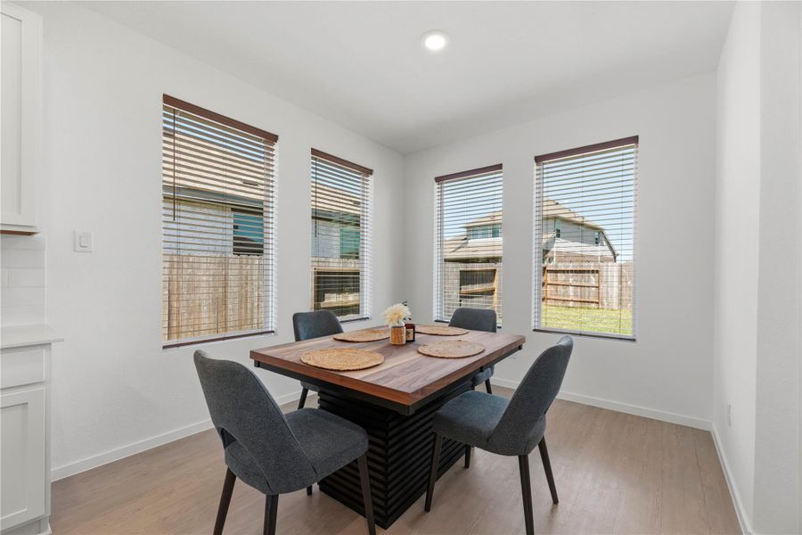 Dining area surrounded by windows, perfect for everyday meals or entertaining.