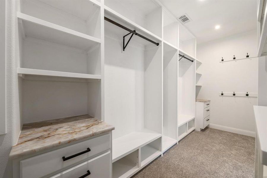 Spacious closet with light colored carpet Spacious closet with light colored carpet