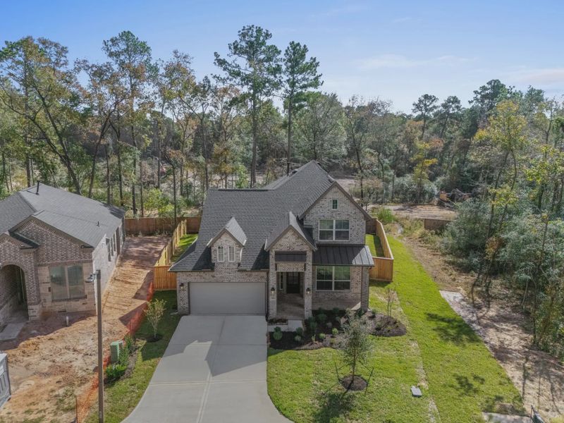 Front exterior of a new home in The Woodlands Hills, Willis, TX, highlighting curb appeal (Image 16).