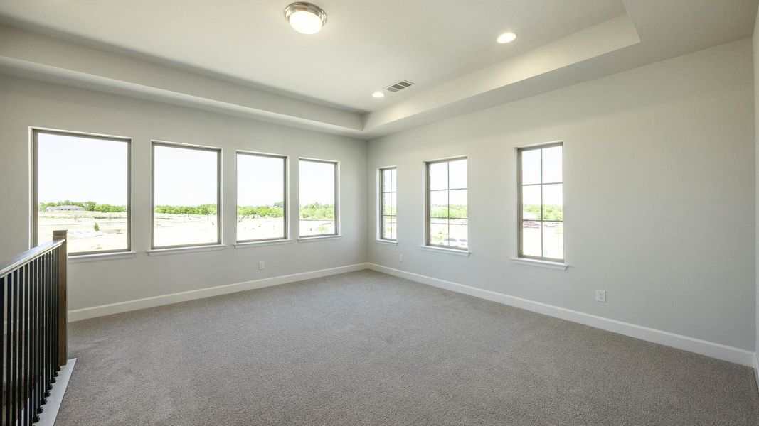 Unfurnished room with a tray ceiling, recessed lighting, baseboards, and carpet floors Unfurnished room with a tray ceiling, recessed lighting, baseboards, and carpet floors