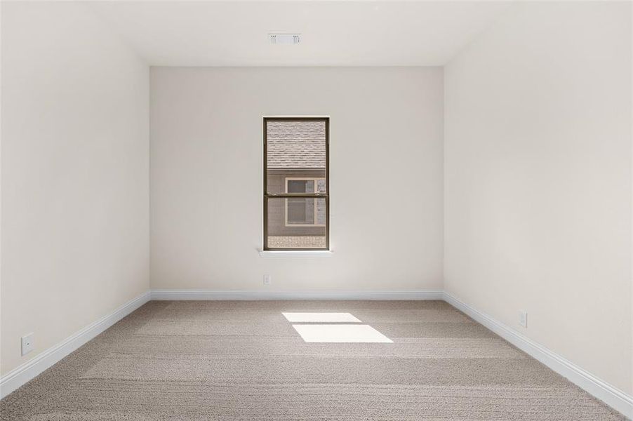 Spare room with light carpet Spare room with light carpet