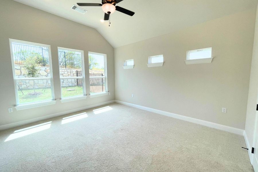 High vaulted ceilings and tall windows frame views of the private yard. High vaulted ceilings and tall windows frame views of the private yard.