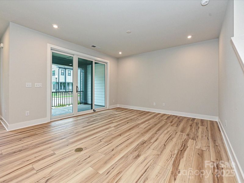 Welcome to the great room with sliding glass doors leading to the outdoor living space.