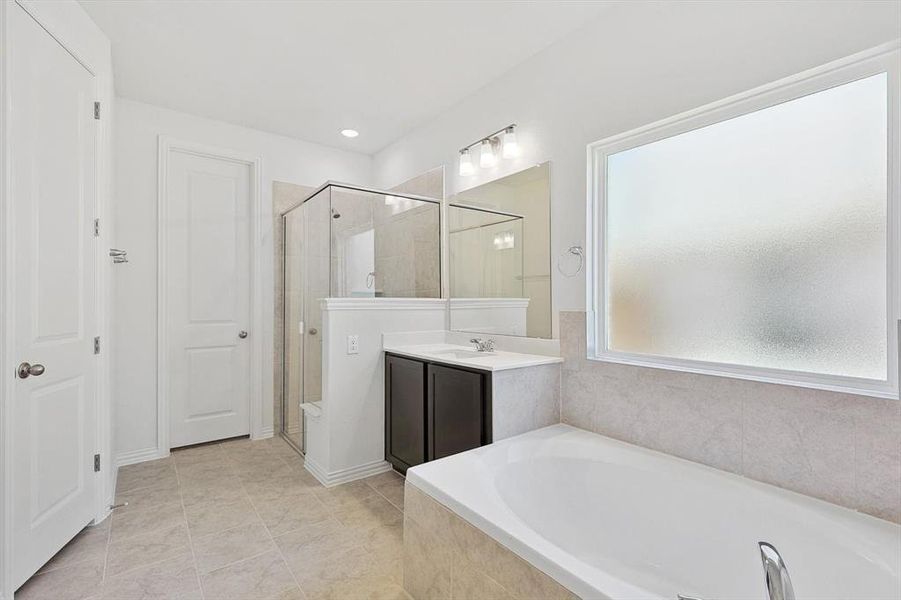 Bathroom with vanity, plus walk in shower, and tile patterned flooring