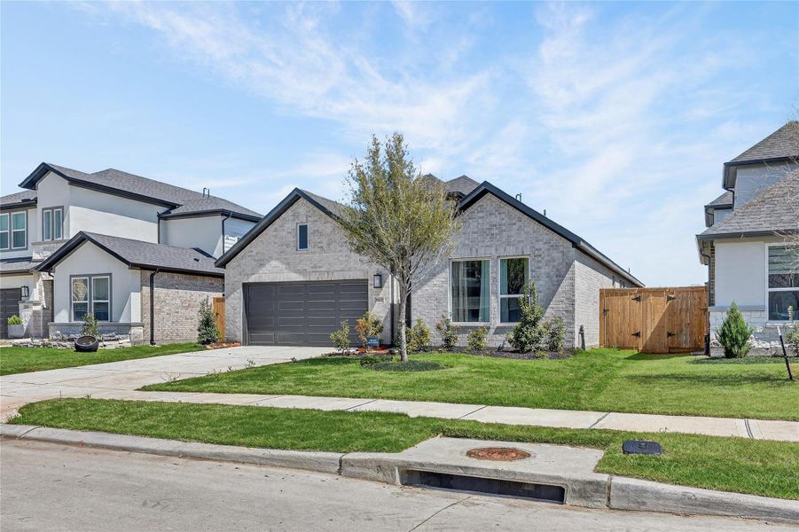 Front exterior of a new home in Trillium, Richmond, TX, highlighting curb appeal (Image 27).