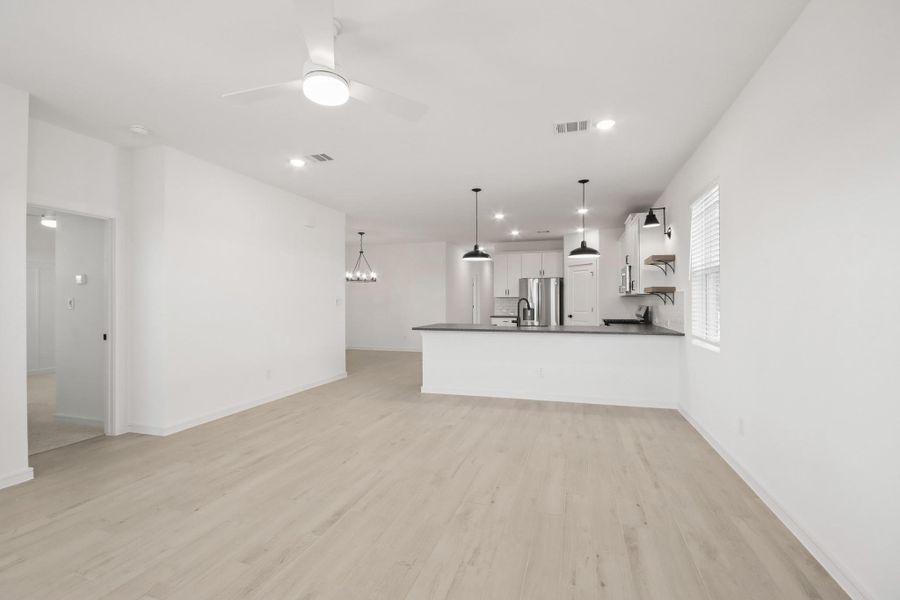 Kitchen open to the great room (*Photo not of actual home and used for illustration purposes only.)