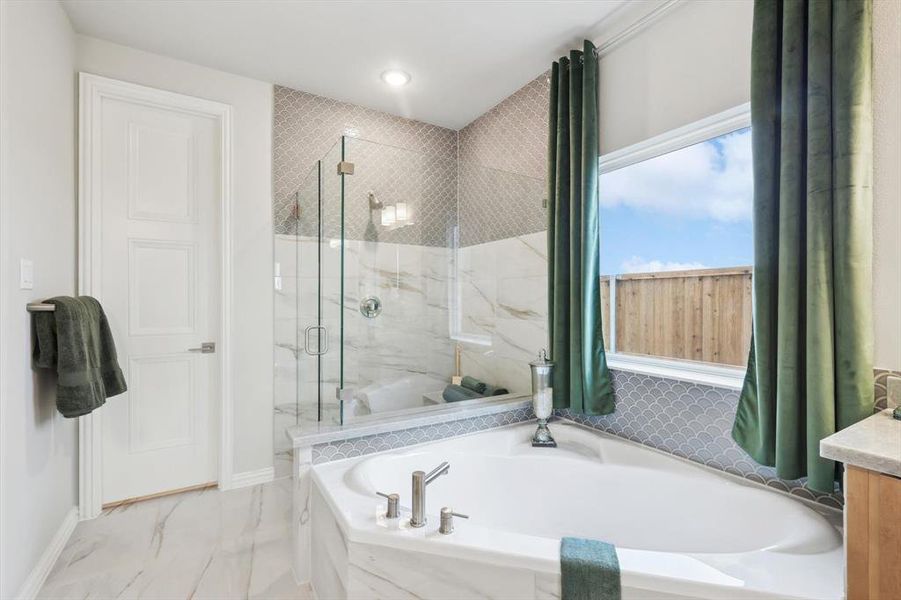 Full bathroom with a marble finish shower, a garden tub, and vanity