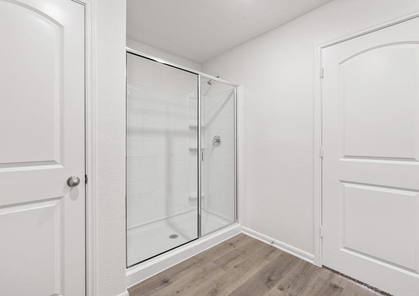 The master bathroom has a large walk-in, glass shower.