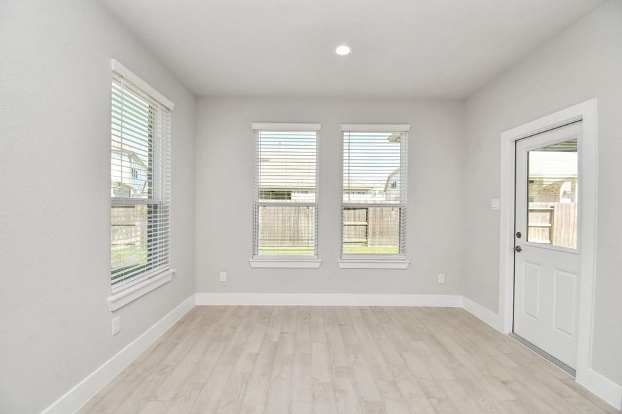 Enjoy breakfast with ease in the connected and cozy breakfast area, seamlessly integrated with the kitchen for utmost convenience. Step through the back door for a breath of fresh air onto the covered patio, extending your living space to the outdoors. Sample photo of completed home with similar floor plan. Actual colors and selections may vary. Enjoy breakfast with ease in the connected and cozy breakfast area, seamlessly integrated with the kitchen for utmost convenience. Step through the back door for a breath of fresh air onto the covered patio, extending your living space to the outdoors. Sample photo of completed home with similar floor plan. Actual colors and selections may vary.