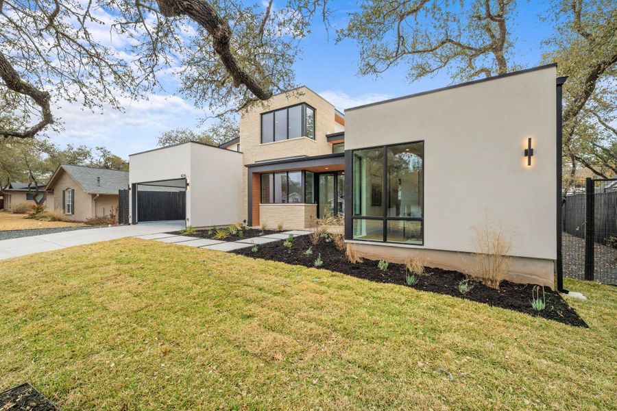 View of front of home with stucco siding, a garage, and concrete driveway