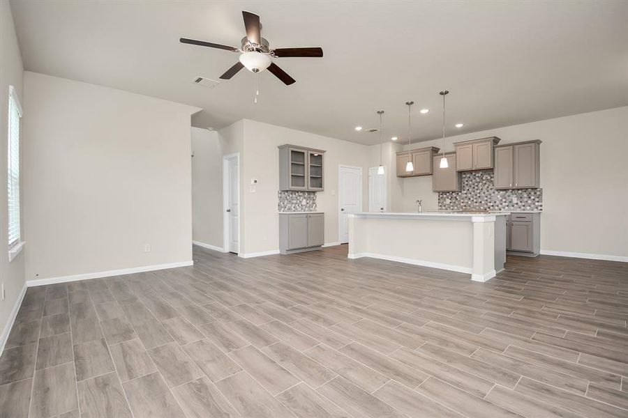 This spacious floorplan seamlessly blends the kitchen, dining, and living areas – perfect for entertaining. *This image is from another Saratoga Home with similar floor plan and finishes, not the Brittany floorplan.*