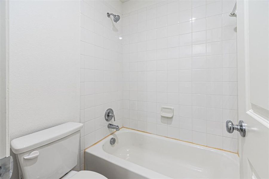 Bathroom with tub / shower combination and toilet