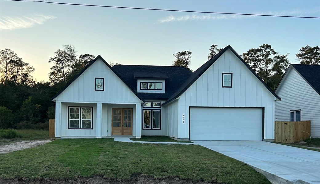 Front exterior of a new home in , Huffman, TX, highlighting curb appeal (Image 1).
