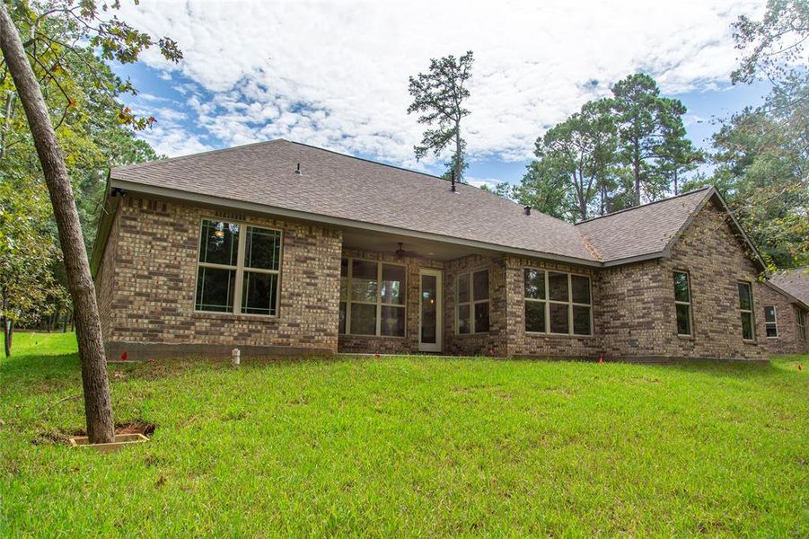 Brick on the sides and back.  This is a sample of the home to be built.