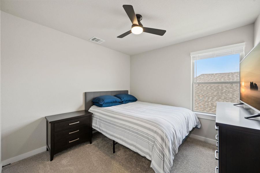 Natural light fills this bedroom complete with neutral carpeting and a single window. Natural light fills this bedroom complete with neutral carpeting and a single window.