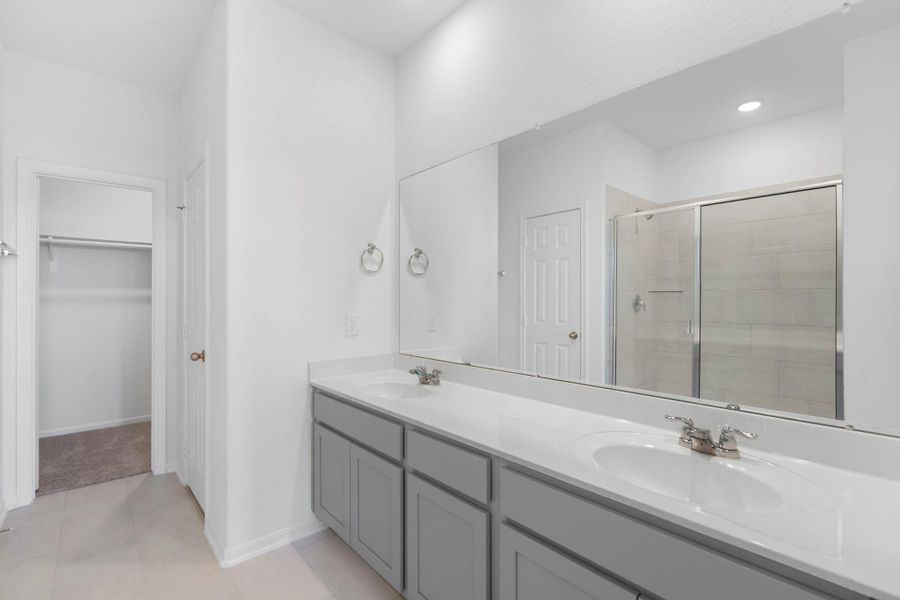 The en-suite bathroom offers a spa-like atmosphere with its elegant design, high end finishes, and tasteful lighting, creating a retreat within your own home. The en-suite bathroom offers a spa-like atmosphere with its elegant design, high end finishes, and tasteful lighting, creating a retreat within your own home.