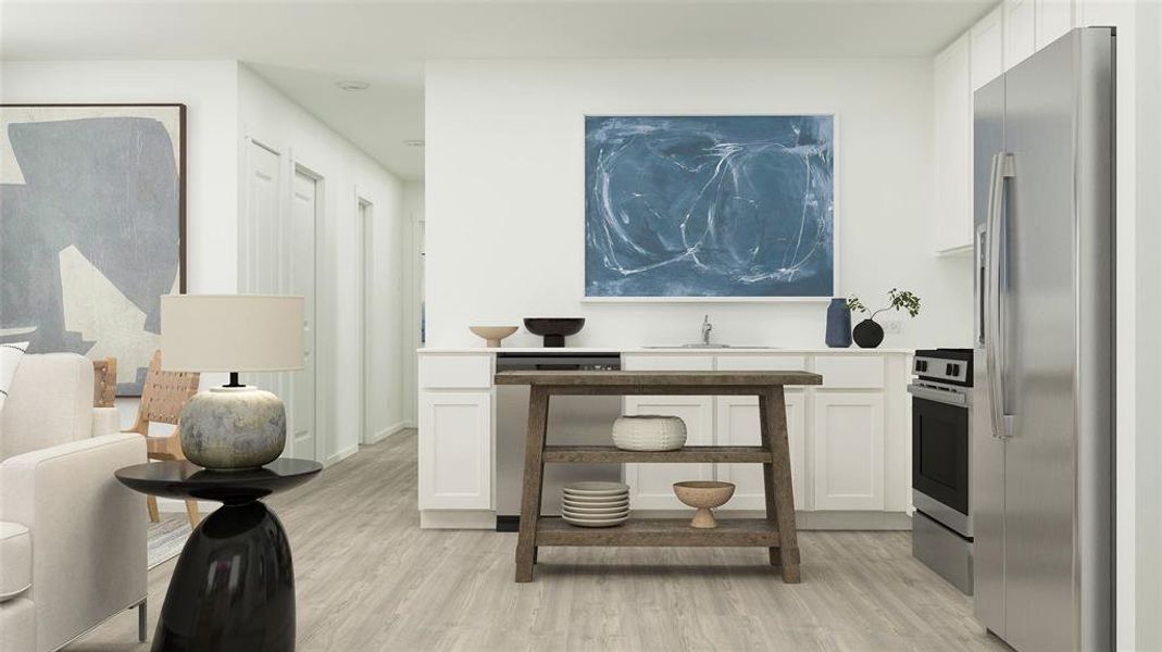 Kitchen with white cabinetry, light hardwood / wood-style floors, and appliances with stainless steel finishes