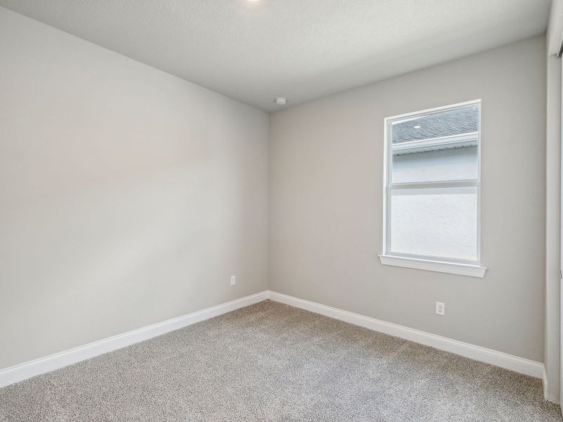 Bedroom in the Onyx floorplan at 6406 NW Sweetwood Drive