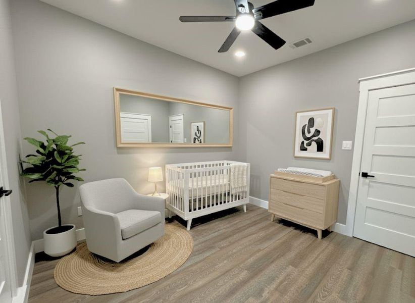 Bedroom featuring light wood-style flooring, a nursery area, a ceiling fan, and recessed lighting Bedroom featuring light wood-style flooring, a nursery area, a ceiling fan, and recessed lighting