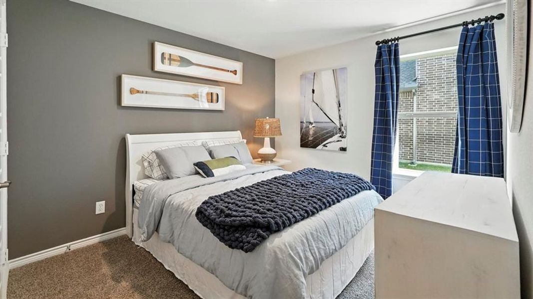 Carpeted bedroom with baseboards