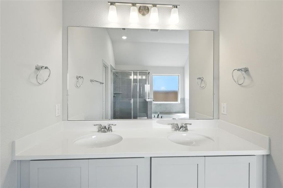 Full bath featuring a stall shower, double vanity, and a bath Full bath featuring a stall shower, double vanity, and a bath