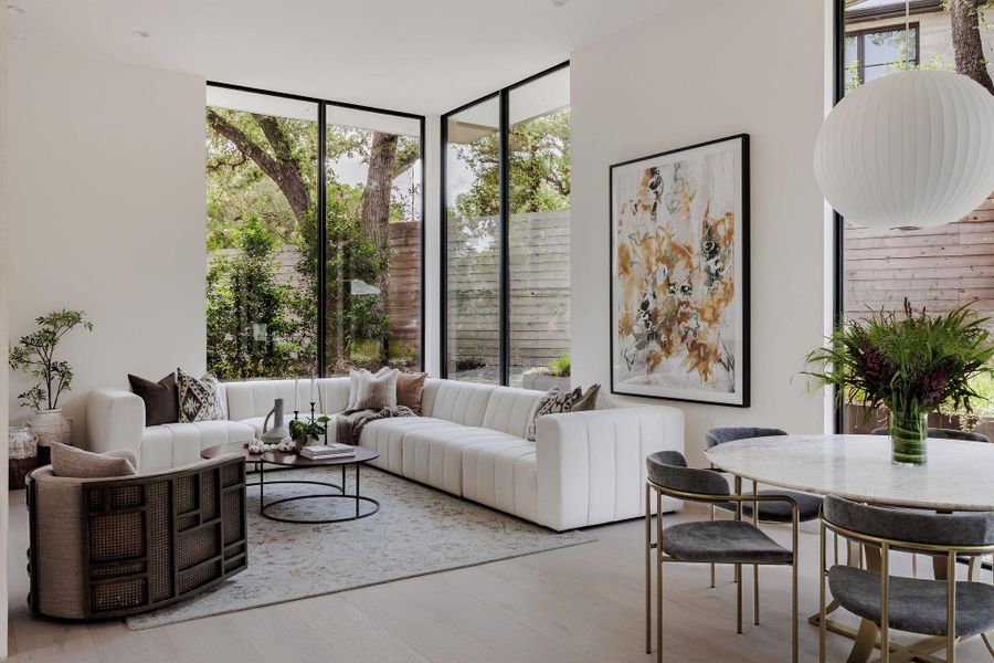 Living area with wood finished floors and expansive windows Living area with wood finished floors and expansive windows