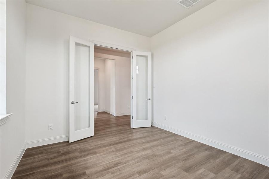 Spare room featuring hardwood / wood-style flooring