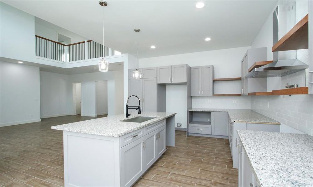 Experience streamlined living with a seamlessly integrated pantry and laundry area within the stylish kitchen cabinetry, optimizing both space and design.