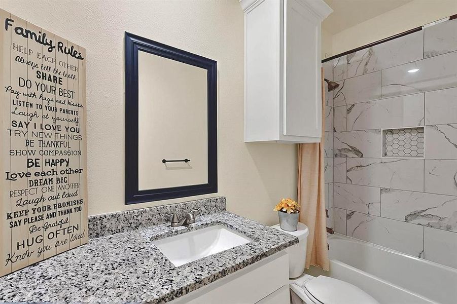 Full bathroom featuring toilet, shower / bath combination, and vanity Full bathroom featuring toilet, shower / bath combination, and vanity