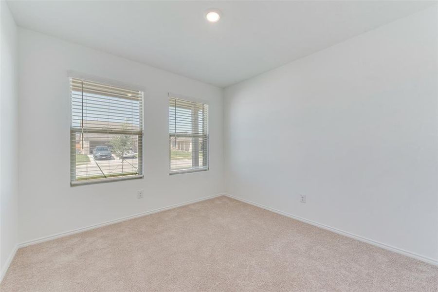 Unfurnished room featuring light colored carpet