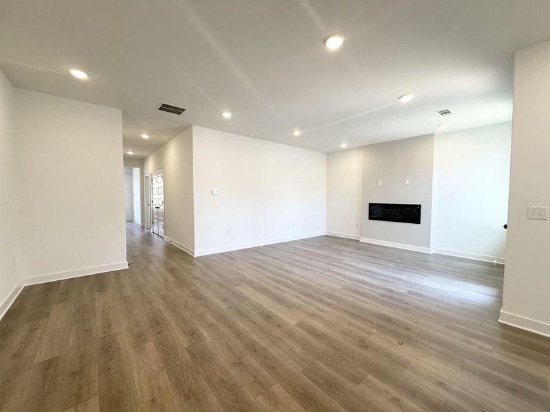 Unfurnished living room featuring recessed lighting, a fireplace, and light wood-style floors