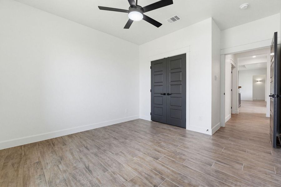 A quiet retreat with a modern ceiling fan and durable tile flooring throughout. A quiet retreat with a modern ceiling fan and durable tile flooring throughout.