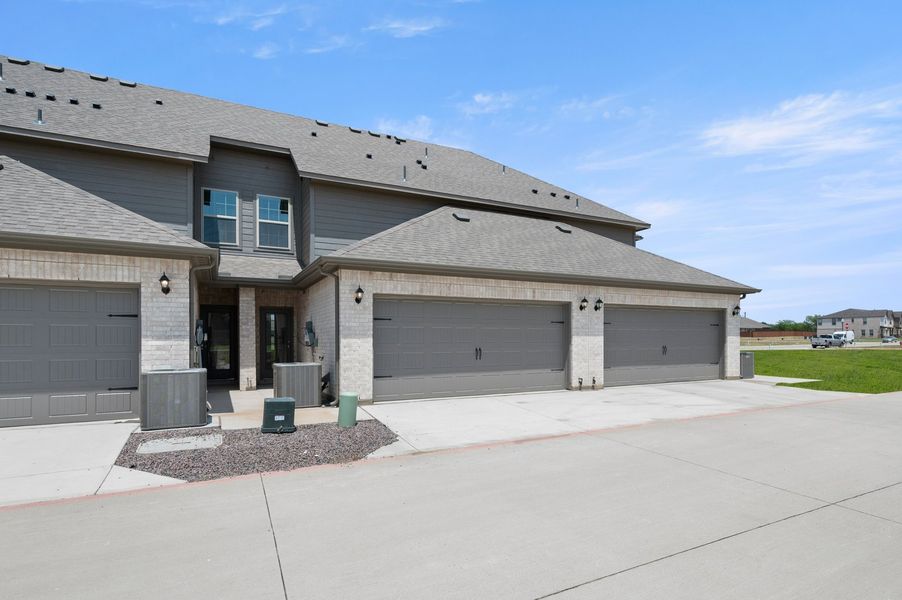 Front exterior of a new home in Sanger Circle – Townhomes, Sanger, TX, highlighting curb appeal (Image 28). Front exterior of a new home in Sanger Circle – Townhomes, Sanger, TX, highlighting curb appeal (Image 28).