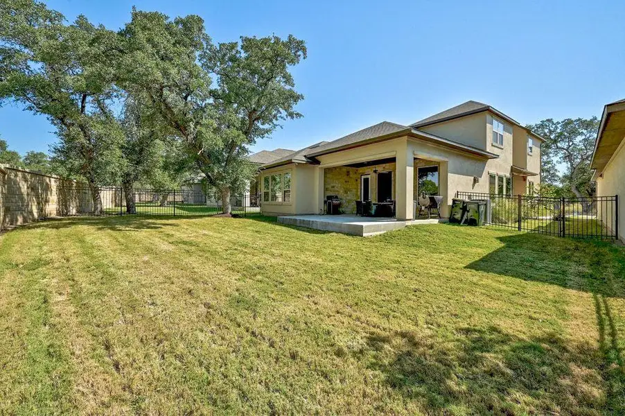 Back of property featuring a fenced backyard, a patio area, stucco siding, and ceiling fan Back of property featuring a fenced backyard, a patio area, stucco siding, and ceiling fan